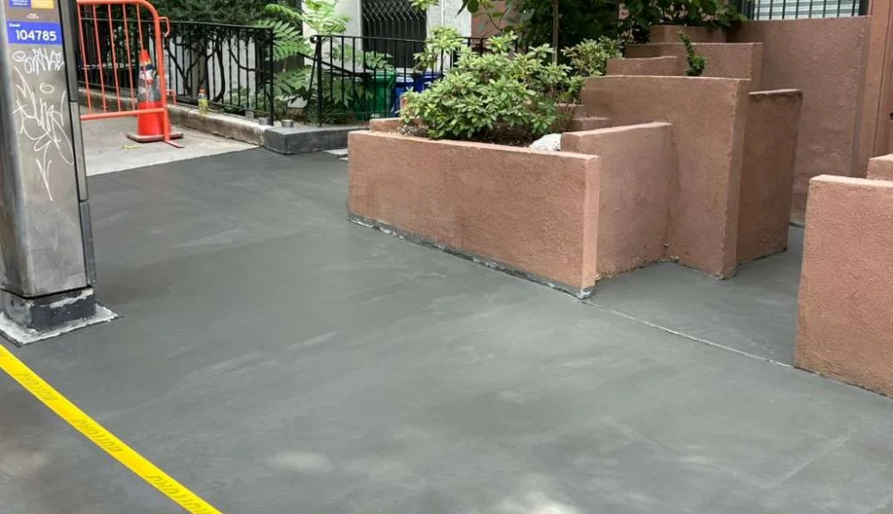 completed sidewalk repair at 151 e 37th st in murray hill with safety barricades in place