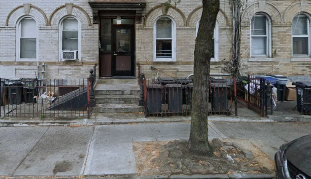 street view of repaired sidewalk outside 1557 dekalb ave near the tree pit and residential entrance