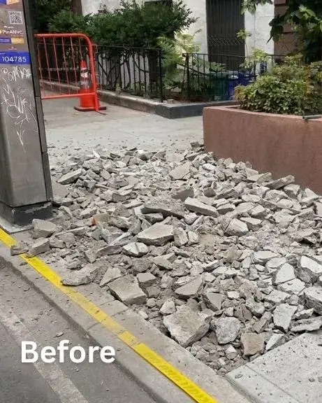 Broken-out sidewalk concrete outside the historic brownstone at 151 E 37th St before replacement