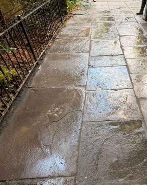 Reset and aligned bluestone sidewalk flags outside 301 Clinton Street in Cobble Hill, Brooklyn, after restoration