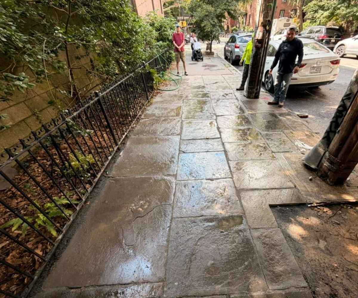 Restored bluestone sidewalk with reset and aligned stone flags at 301 Clinton Street in Cobble Hill, Brooklyn.