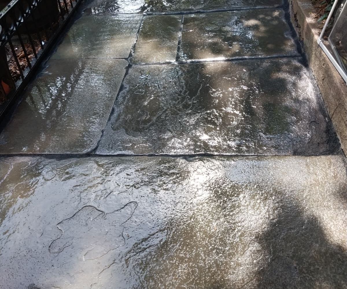 Repaired and sealed joints between existing bluestone sidewalk flags after joint and crack repair in Park Slope, Brooklyn.