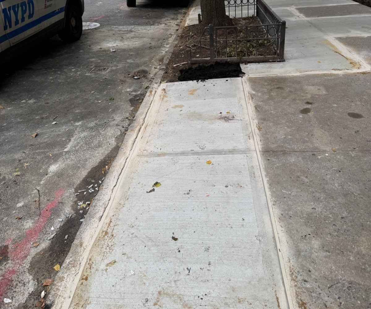 Completed concrete sidewalk repair at 225 Park Pl in Prospect Heights, Brooklyn, after replacement of deteriorated sidewalk slabs.